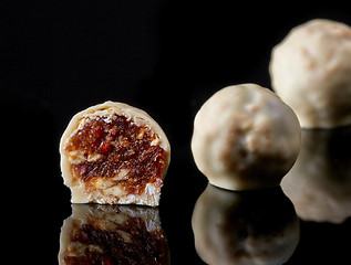 Image showing dried nuts and raisins candies covered with white chocolate