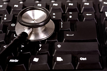 Image showing Stethoscope and computer keyboard