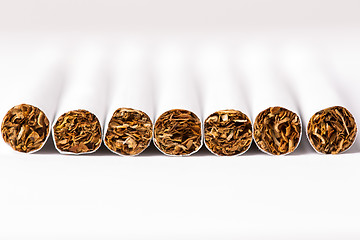 Image showing Cigarettes arranged in a row, a background