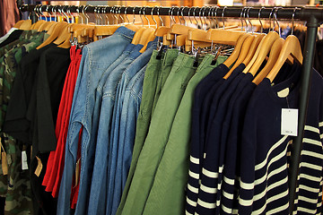 Image showing Fashion clothing on hangers in a shop