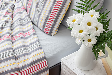 Image showing Bright bedroom decorated with white flowers