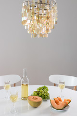 Image showing Decorative chandelier and table setting with wine