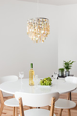 Image showing Room with decorative chandelier and white round table