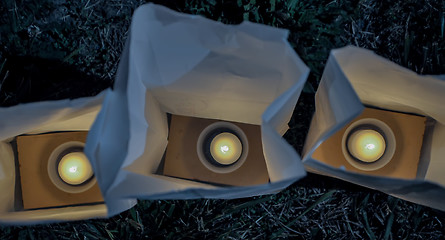 Image showing candles in white paper bag  close up shot