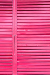 Image showing Red roller metal entry door of apartment