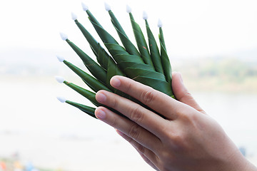 Image showing Hands pay respect rice offering to natural surroundings