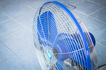 Image showing Turn off industrial fan on blue floor