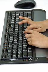 Image showing Hands typing on a computer key board