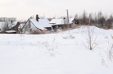 Image showing old wooden houses with abundant snowy rooftops  