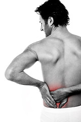 Image showing Young man holding his lower back in pain