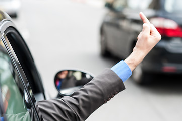 Image showing Man showing middle finger from car window