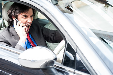 Image showing Angry businessman shouting while driving