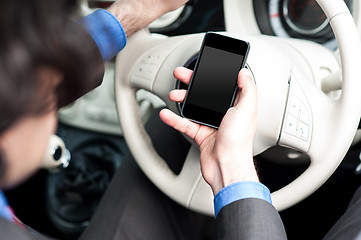 Image showing Man using mobile phone while driving
