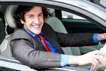 Image showing Young businessman driving his car