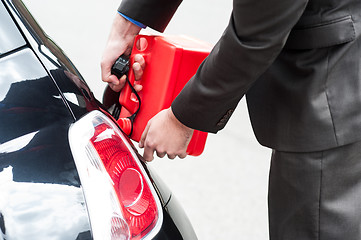 Image showing Man refueling his car