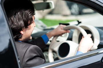 Image showing Businessman driving his luxury dream car