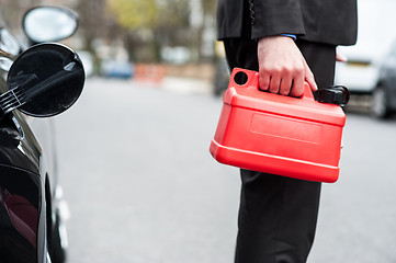 Image showing Man holding fuel can, cropped image