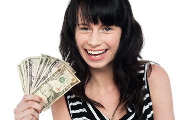 Image showing Attractive young girl holding currency fan