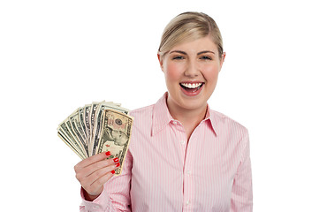 Image showing Excited girl holding currency notes fan