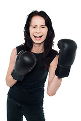 Image showing Smiling young slim female boxer
