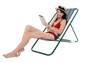 Image showing Bikini woman holding touch screen tablet device