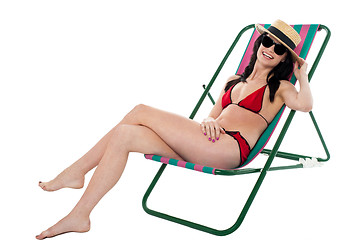 Image showing Young bikini woman relaxing on deckchair