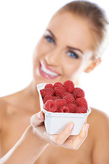 Image showing Close up of smiling blonde holding raspberries