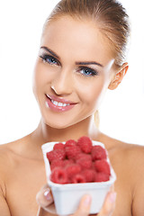 Image showing Close up of smiling blonde holding raspberries