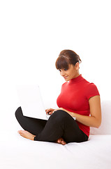 Image showing Girl with laptop on couch
