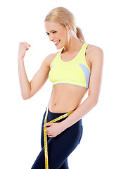 Image showing Happy sporty woman showing her muscle