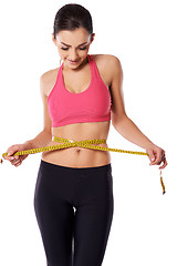 Image showing Female athlete measuring her waist
