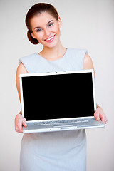Image showing Young attractive business woman with laptop computer