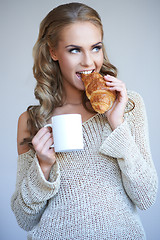 Image showing Cute girl holding white cup  and croissant while isolated