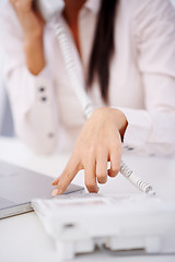 Image showing Close up of a woman dialing on telephone