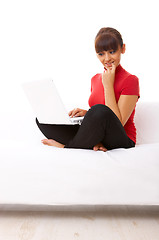 Image showing Girl with laptop on couch