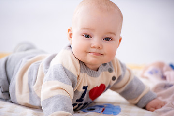 Image showing Contented little baby smiling at the camera