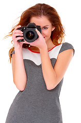 Image showing Woman in gray dress wit digtal camera on white