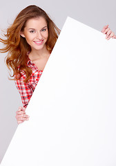 Image showing Young woman in casual clothing holding empty board