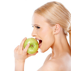 Image showing Side view of blond woman  she bites an apple