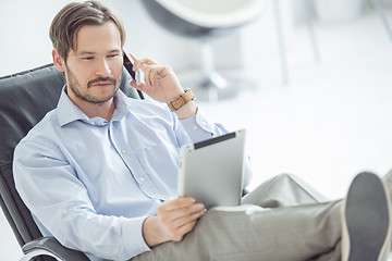 Image showing Relaxed businessman talking mobile phone