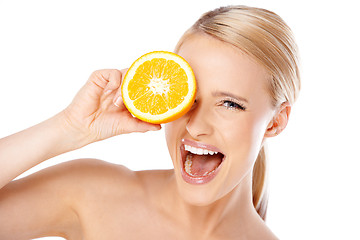 Image showing Blond woman with beautiful smile holding orange