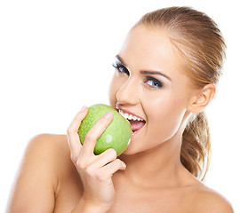 Image showing Beautiful  young woman bites a green apple