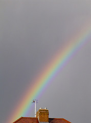 Image showing Rainbow over a rooftop