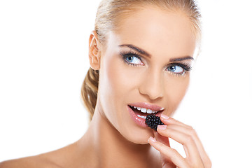 Image showing Close up of beautiful woman eating blackberries