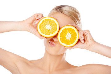 Image showing Blond woman making glasses with orange halfs