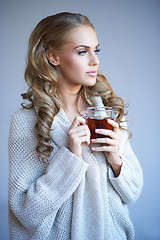 Image showing Daydreaming woman drinking tea