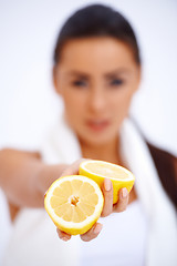 Image showing Close up of a woman showing fresh lemon