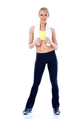 Image showing Happy sporty blond woman standing on white