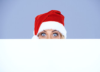 Image showing Woman head and eyes with Santa hat above white board