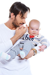 Image showing Young father cradling his baby on his arm